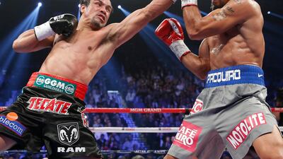 Marquez lands a left against Manny. AP Photo/Eric Jamison