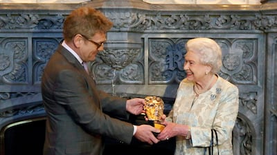 Queen Elizabeth receives an honorary Bafta from actor Kenneth Branagh at Windsor Castle. Getty