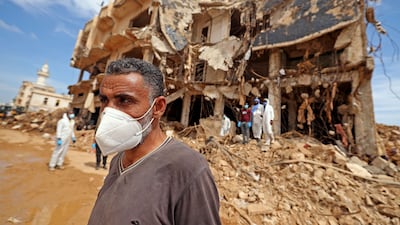 Rescue teams assist in relief work in Libya's eastern city of Derna on Sunday following deadly flash floods. AFP