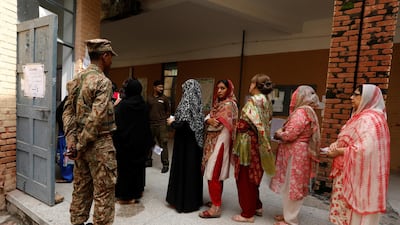 A soldier keeps watch as voters line up to enter at a polling station during general election in Rawalpindi, Pakistan July 25, 2018. Faisal Mahmood / Reuters