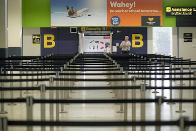 Empty lines ahead of a security gate at Manchester Airport in the UK. Getty
