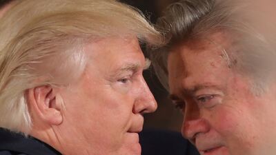 Donald Trump, the US president at the time, talks to chief strategist Steve Bannon during a swearing-in ceremony for senior staff at the White House in 2017. Reuters