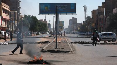 Protesters block a street during a rally in Khartoum this week to protest the deal in which Prime Minister Abdalla Hamdok was reinstated after his removal in October. AFP