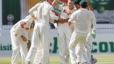 Australia's Peter Siddle is congratulated by teammates after taking a wicket against South Africa.