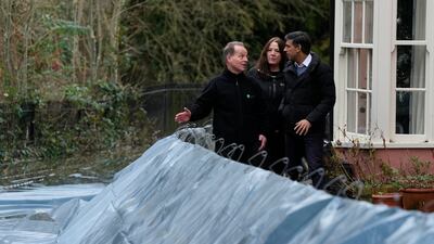 Prime Minister Rishi Sunak looks at flood defences in Oxford. Getty Images