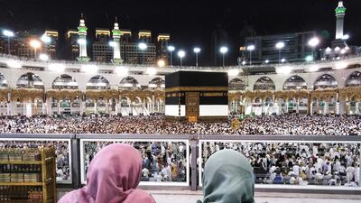 Worshipers watch as others circle around the Kaaba, at the Grand Mosque in Saudi Arabia's holy city of Mecca. AFP