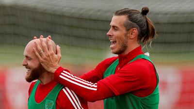 Gareth Bale shares a joke with Jonny Williams during training with Wales. Reuters