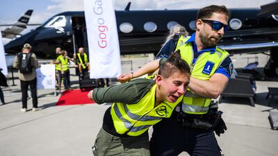 Environmental activists engage in a climate protest at the European Business Aviation Convention and Exhibition at Geneva Airport in Switzerland. EPA