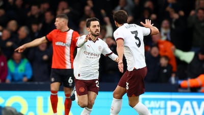 Manchester City's Bernardo Silva celebrates scoring their first goal with teammate Ruben Dias. Action Images