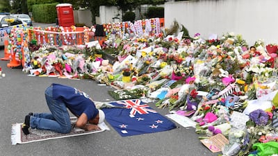 A man pays his respects at a makeshift memorial to victims of the 2019 terror attacks on mosques in Christchurch, New Zealand. EPA