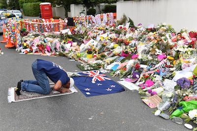 A man prays at a memorial for the 2019 Christchurch mosque attacks in which a gunman killed 51 worshippers. EPA