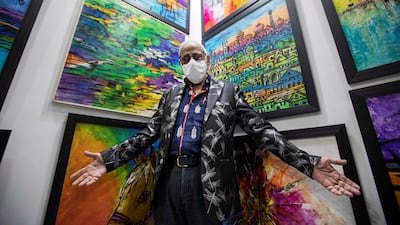 Artist Anjini Prakash Laitu with his artworks at the World Art Dubai. Leslie Pableo / The National