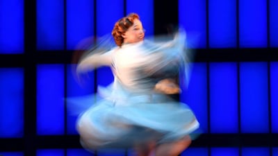 A picture taken with a slow shutter speed shows a performer singing and dancing on stage during a media call for Singin’ in the Rain at Her Majesty’s Theatre in Melbourne. Tracey Nearmy / EPA