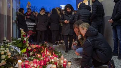 People gather in front of the Arena Bar to commemorate the victims of the shooting. Thomas Lohnes/Getty Images