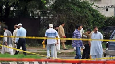 Pakistani investigators collect evidence at the suicide attack site in Islamabad.