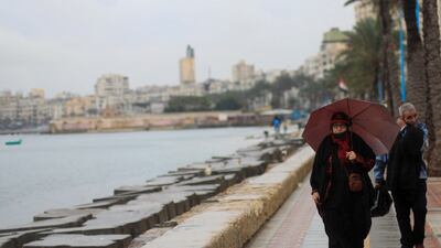 People walk during rainy weather in Alexandria. Egypt’s transportation sector is the second largest contributor to the country’s greenhouse emissions after energy. Reuters