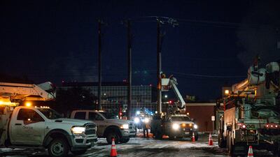 Workers from Oncor Electric Delivery repair a utility pole that was damaged by the winter storm that passed through Odessa, Texas. AP