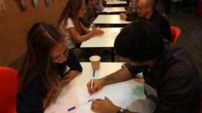 Participants exchange languages and ideas during a Speak Dating event held at The Shelter in Dubai.