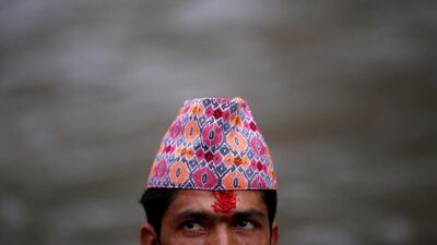 A Hindu priest’s forehead is covered with “tika”, coloured powder and rice used as a blessing, during the Janai Purnima festival (Sacred Thread Festival) at Pashupatinath Temple in Kathmandu, Nepal. Hindus take holy baths and change their sacred thread, also known as Janai, for protection and purification, during the festival. Navesh Chitrakar / Reuters