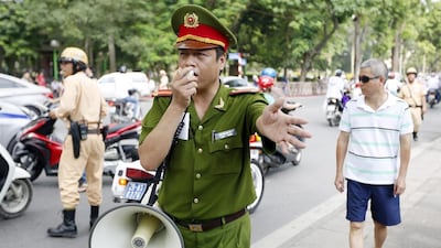 Policemen trying to disperse people protesting near the Chinese embassy in Hanoi, Vietnam on May 18, 2014. Growing anti-China sentiments in Vietnam have killed at least two Chinese citizens, prompting Beijing to pull out its citizens in the Southeast Asian country. Luong Thai Linh/EPA