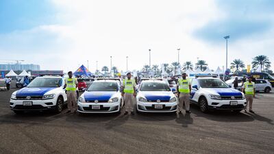Abu Dhabi police officers stand by their vehicles before heading out with the 400-strong convoy.