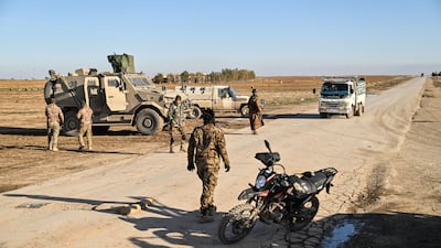 Syrian government troops man a position 10km from the city of Hasakah, as they advance into north-eastern Syria. Getty Images
