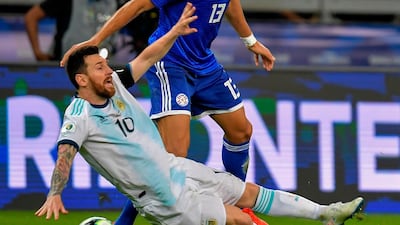 Argentina's Lionel Messi is fouled by Paraguay's Junior Alonso. AFP
