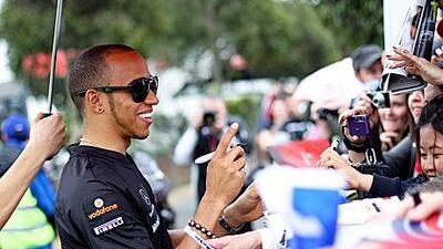 Lewis Hamilton signs autographs for fans as he arrives at the Albert Park circuit in Melbourne. The Briton needs an improved car to win this season.
