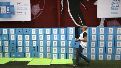 Volunteers pack Iftar boxes for charity. Jeffrey E Biteng / The National