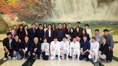 Kim Jong-un, centre, together with his wife Ri Sol Ju, pose for a group photograph with K-pop artists after enjoying the performance 'Spring Comes', given by an art troupe from South Korea, at the East Pyongyang Grand Theatre in Pyongyang, North Korea. KCNA / EPA