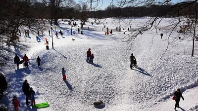 People go sledding following a snow storm in Prospect Park in the Brooklyn borough of New York City. Spencer Platt/Getty Images/AFP