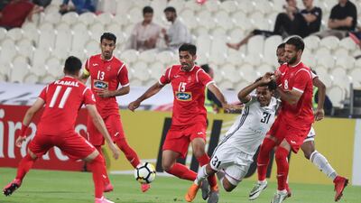 Al Jazira's Romario, second right, and Persepolis players Hossein Mahini, left, Mohammed Ansari, centre, and Ahmed Nourollahi, right, vie for the ball during their Asian Champions League game at Mohammed bin Zayed Stadium in Abu Dhabi. Karim Sahib / AFP