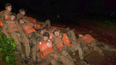 Paramilitary policemen rest as they take turns to try to fill up a break in a dam in preparation for Typhoon Nepartak which is approaching China, in Lujiang county, Anhui province, China. Reuters / Stringer