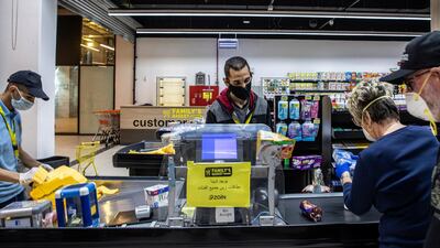 Masked customers and employees at supermarket in Amman, Jordan. Authorities allowed malls and supermarkets to open on Monday under strict conditions, but a wider lockdown remains in place until April 30, adding to the kingdom's economic strain. EPA