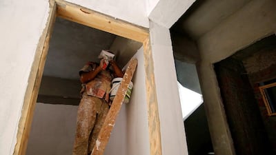 A worker completes his job at one of the government-built new buildings. Amr Abdallah Dalsh/Reuters