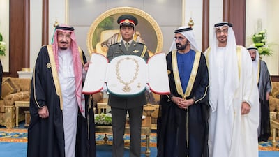 ABU DHABI, UNITED ARAB EMIRATES - 16, 03, 2016: HH Sheikh Mohamed bin Rashid Al Maktoum, Vice-President, Prime Minister of the UAE, Ruler of Dubai and Minister of Defence (2nd R) and HH Sheikh Mohamed bin Zayed Al Nahyan, Crown Prince of Abu Dhabi and Deputy Supreme Commander of the UAE Armed Forces (R) present a Zayed Medal to HM King Salman Bin Abdulaziz Al Saud, of Saudi Arabia and Custodian of the Two Holy Mosques (L) during a reception held at Mushrif Palace. ( Mohamed Al Suwaidi / Crown Prince Court - Abu Dhabi ) --- *** Local Caption *** na04de-Award.jpg