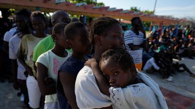Haitians who arrived in Cuba while trying to sail to the US queue for health care and to be registered at a tourist campsite in Sierra Morena, Villa Clara province. They were on a vessel carrying more than 800 Haitians who were trying to reach the US, Cuban state media said on Wednesday. AP