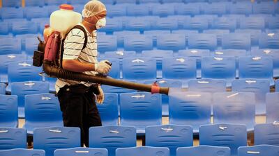 A worker disinfects a auditorium after classes were suspended for sanitation operations in an elementary school in Cainta town of Rizal province, east of Manila. EPA