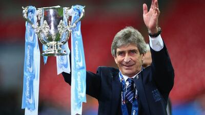 Manuel Pellegrini manager of Manchester City celebrates victory with the trophy after the Capital One Cup Final match between Liverpool and Manchester City at Wembley Stadium on February 28, 2016 in London, England. Manchester City won 3-1 on penalties. (Photo by Clive Brunskill/Getty Images)