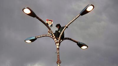 A Yemeni youth holds a poster of Egypt's ousted President Mohammed Morsi during a rally supporting Morsi in Sanaa. Hani Mohammed / AP Photo