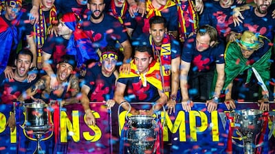 Barcelona players celebrate with La Liga, Copa del Rey and Champions League trophies during their victory parade after winning the UEFA Champions League Final at the Camp Nou Stadium on June 7, 2015 in Barcelona, Spain. (Photo by David Ramos/Getty Images)