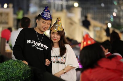 Visitors pose outside Tim Hortons in The Dubai Mall on New Year's Eve 2019. Pawan Singh / The National