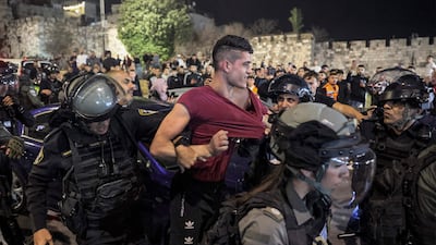Israeli policemen detain a Palestinian man. AFP