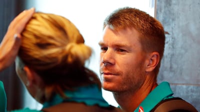 Australian cricket player David Warner, centre, departs from Cape Town International airport. Nic Bothma / EPA