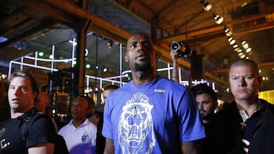 NBA basketball star LeBron James walks surrounded by security guards as he attends a promotional event at Phenom House, in Rio de Janeiro, Brazil on Saturday, July 12, 2014. James who will attend the final game of the 2014 soccer World Cup, has announced his return to play for the Cleveland Cavaliers after four years in Miami. AP