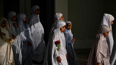 Iraqi girls wear a hijab for the first time, during a ceremony at the Basra International Stadium. AFP