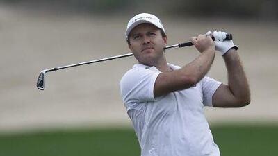 Richard Sterne from South Africa plays a ball on the 12th hole during the second round of the Dubai Desert Classic on Friday. Sterne holds a slim one-shot lead on the field. Kamran Jebreili / AP Photo