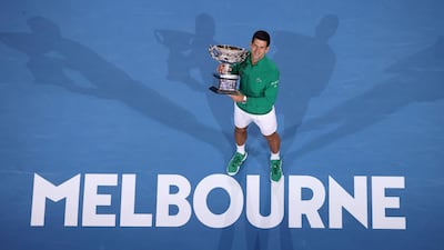 Novak Djokovic holds the Norman Brooks Challenge Cup after beating Dominic Thiem in the Australian Open final on Sunday. AFP