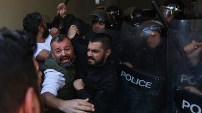 Security forces push back relatives of victims as they try to push their way into the palace after breaking through an external gate. AFP