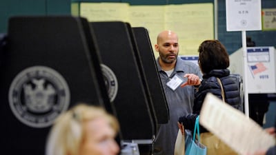 Ashraf Kharrubi, a Palestinian American, assists voters during the 2016 Presidential Election at a polling station in the Bay Ridge neighbourhood of Brooklyn. Kholood Eid / Reuters